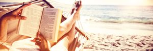 Lazy person in a hammock reading a book